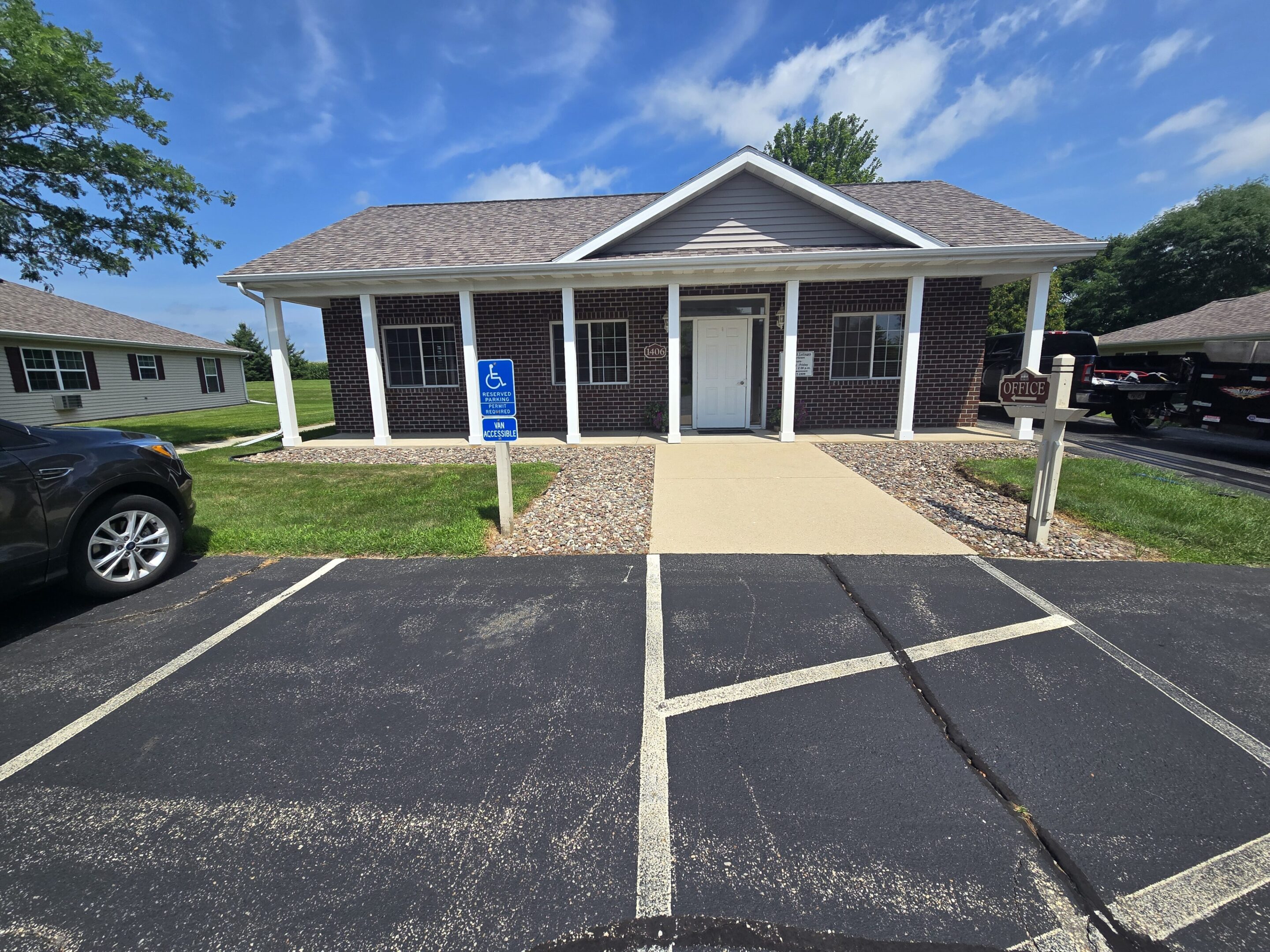 A small brick post office building with a clear blue sky.