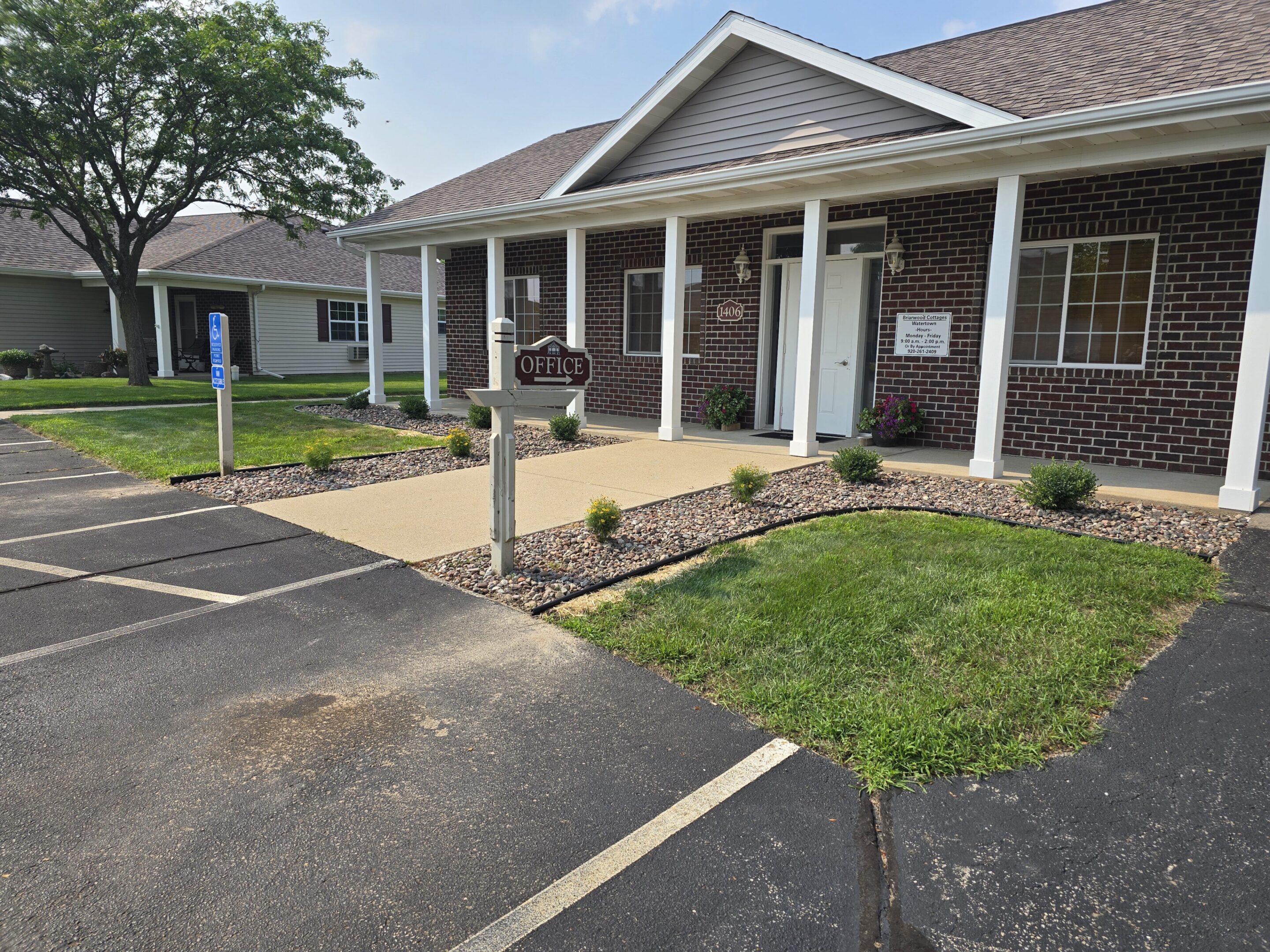A neat house entrance with a small garden and porch.